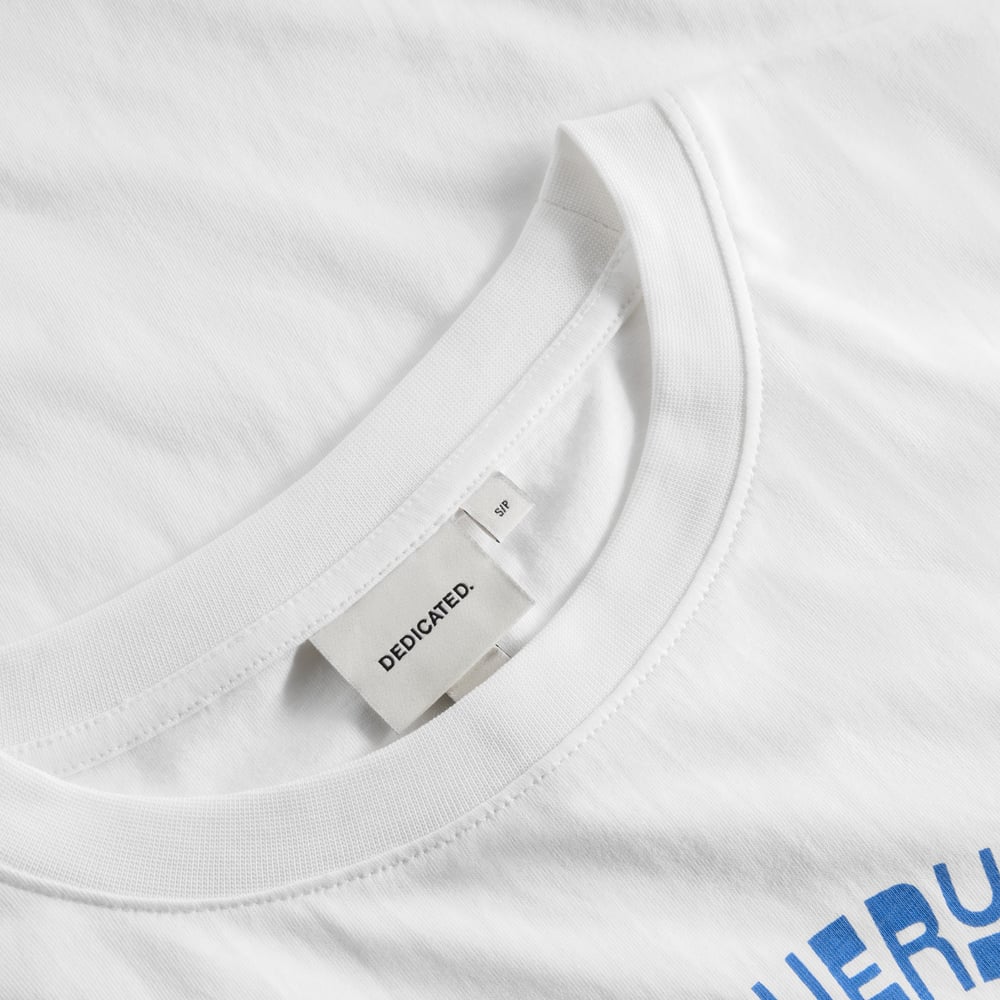 Close-up of the T-shirt Vadstena Dancing Man in white, showing the ribbed crew neck and the Dedicated brand label.