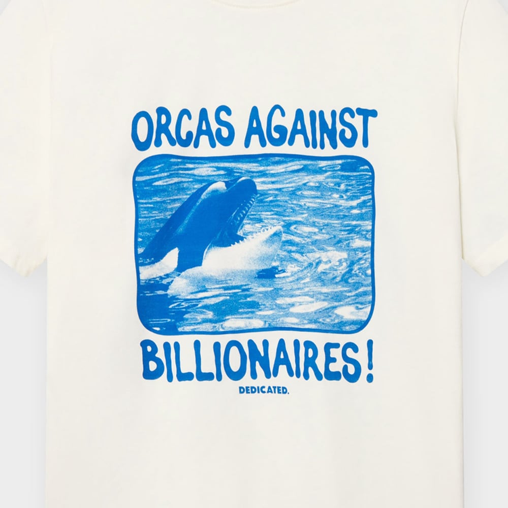 A close-up of the off-white Stockholm t-shirt showing the 'Orcas Against Billionaires!' print with its cool blue orca.