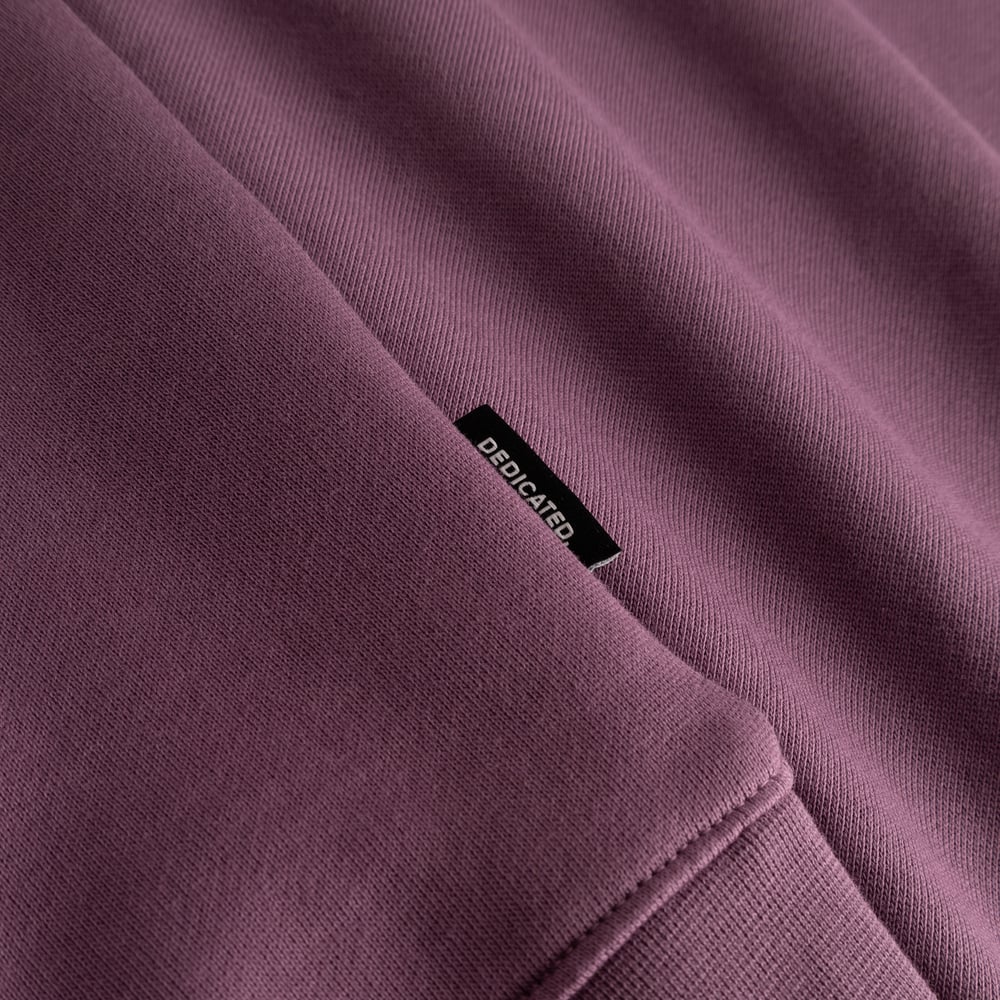 Close-up of the Sweatshirt Malmoe Base in Berry Purple, showing the soft organic cotton and the black Dedicated brand tag.