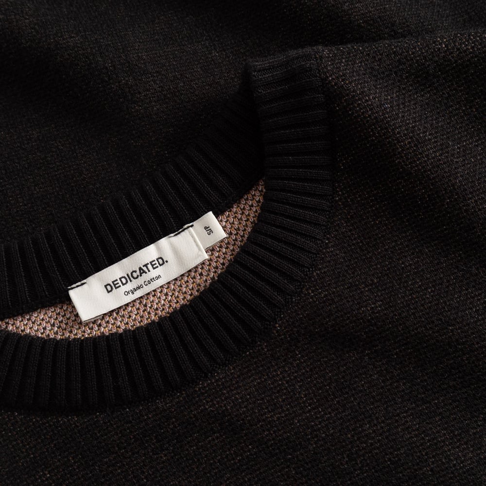 Get up close with the Sweater Arendal Long Cat. See the fine jacquard knit and soft ribbed neckline in classic black.