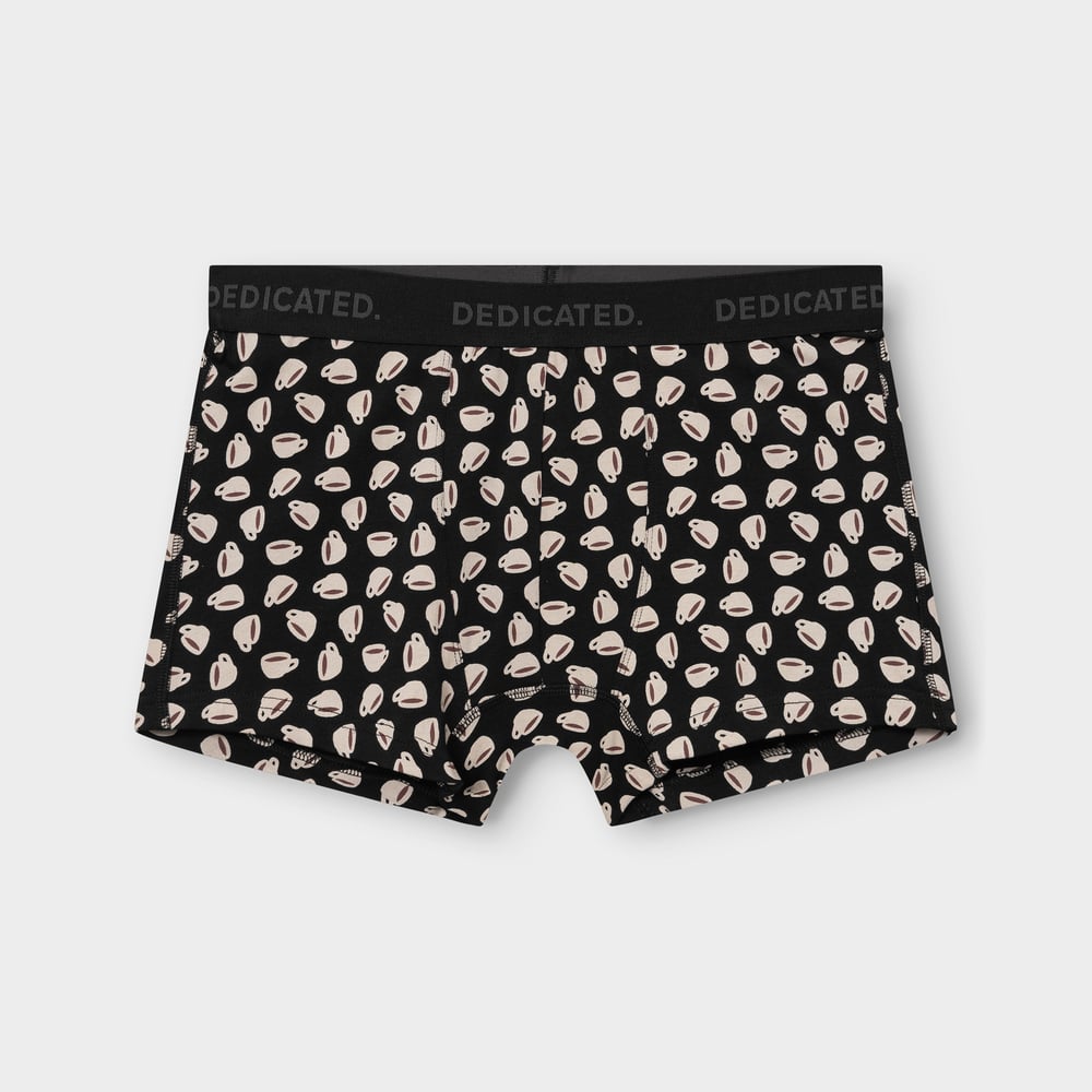 A pair of black boxer briefs with a fun all-over coffee cup print, photographed flat on a grey background.
