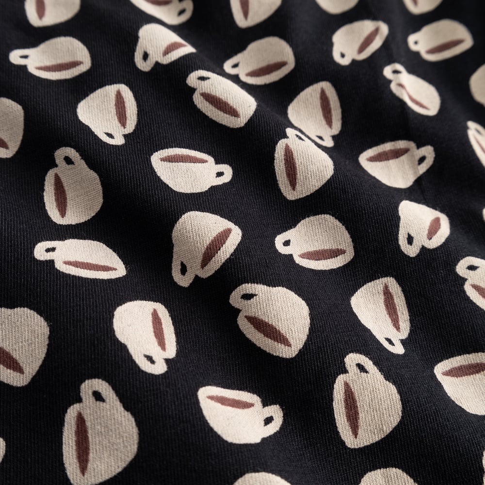A close-up of the fun all-over coffee cup print on the black fabric of the Kalix Boxer Briefs.