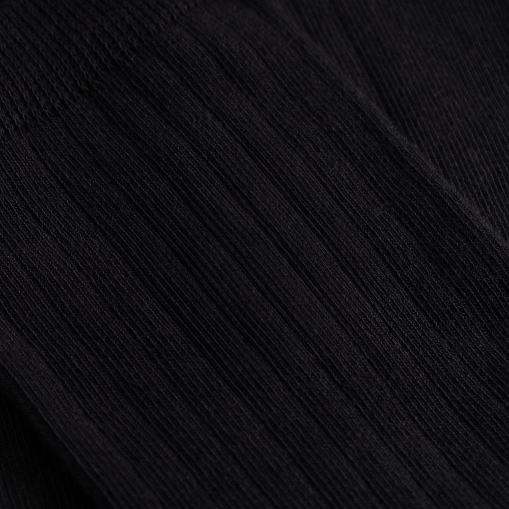 A detailed close-up of the fine ribbed texture on the black Knivsta socks.