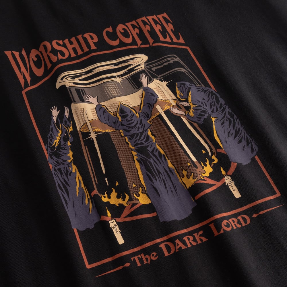 Close-up of the 'Worship Coffee' graphic by Steven Rhodes on the black Stockholm T-shirt, showing robed figures.
