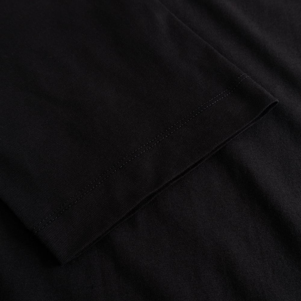 Close-up of the sleeve detail on the T-shirt Vadstena Hanging With All My Friends, showing the soft black organic cotton.