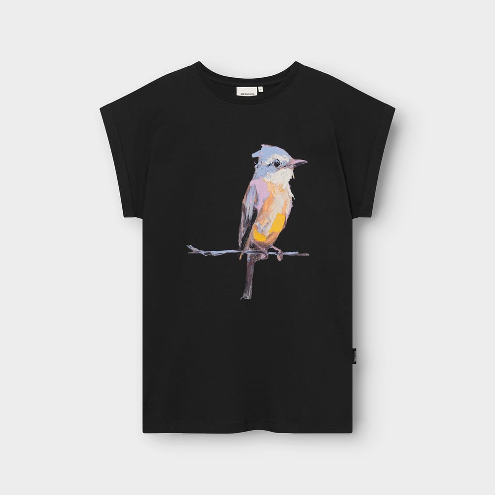 A black women's t-shirt with rolled sleeves featuring a colorful, artistic print of a bird on a branch.