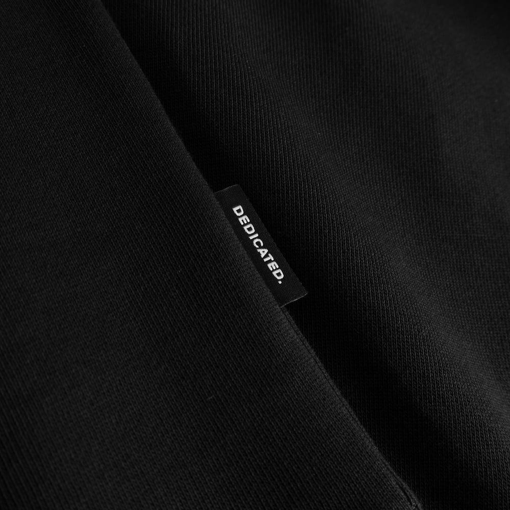 Close-up of the soft black fabric and side tag on the Dedicated Hoodie Falun Cheers Salud.