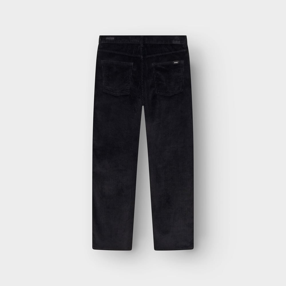 Back view of the Hamburg Corduroy Pants in black, laid flat to show the relaxed fit and back pockets.