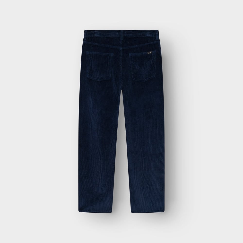 Back view of the relaxed-fit Hamburg corduroy pants in navy, laid flat against a light grey background.