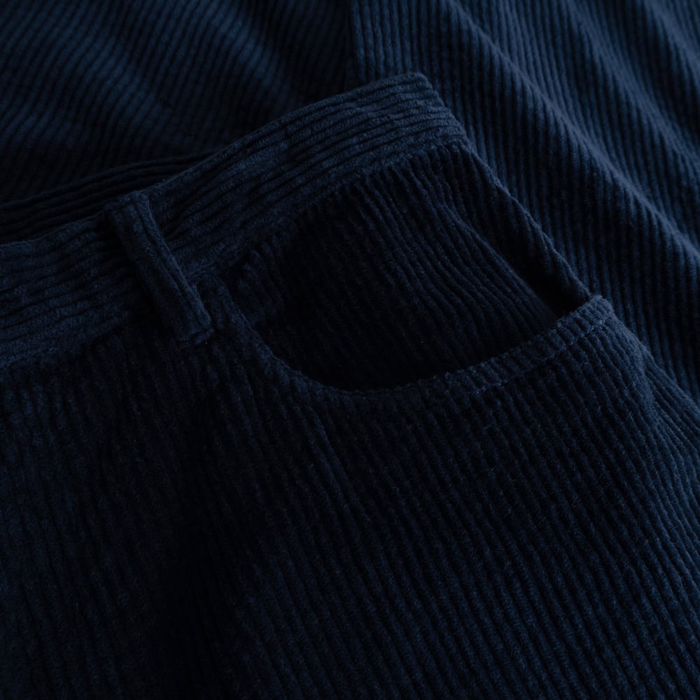 A close-up image showing the rich texture and deep navy colour of the corduroy fabric on the Pants Hamburg.