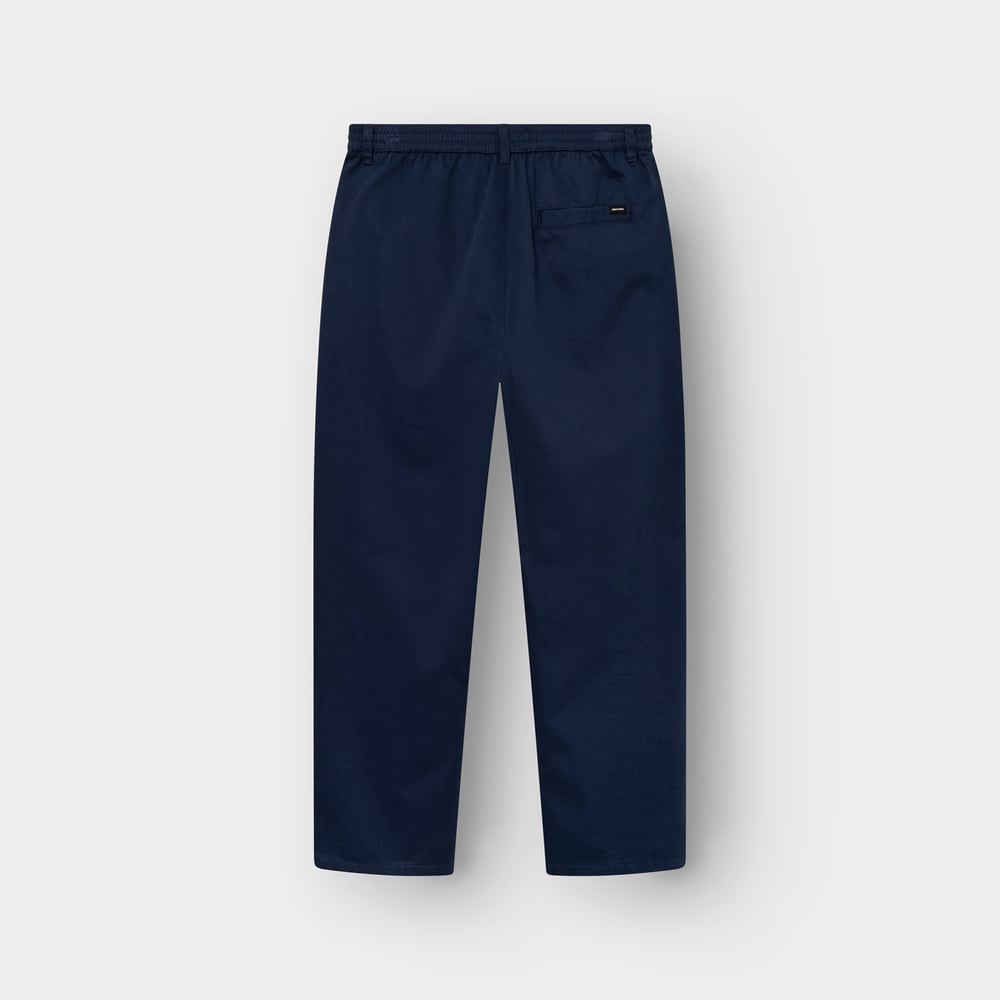 Back view of the navy Hudiksvall chino pants, laid flat to show the elasticated waistband and back pocket detail.