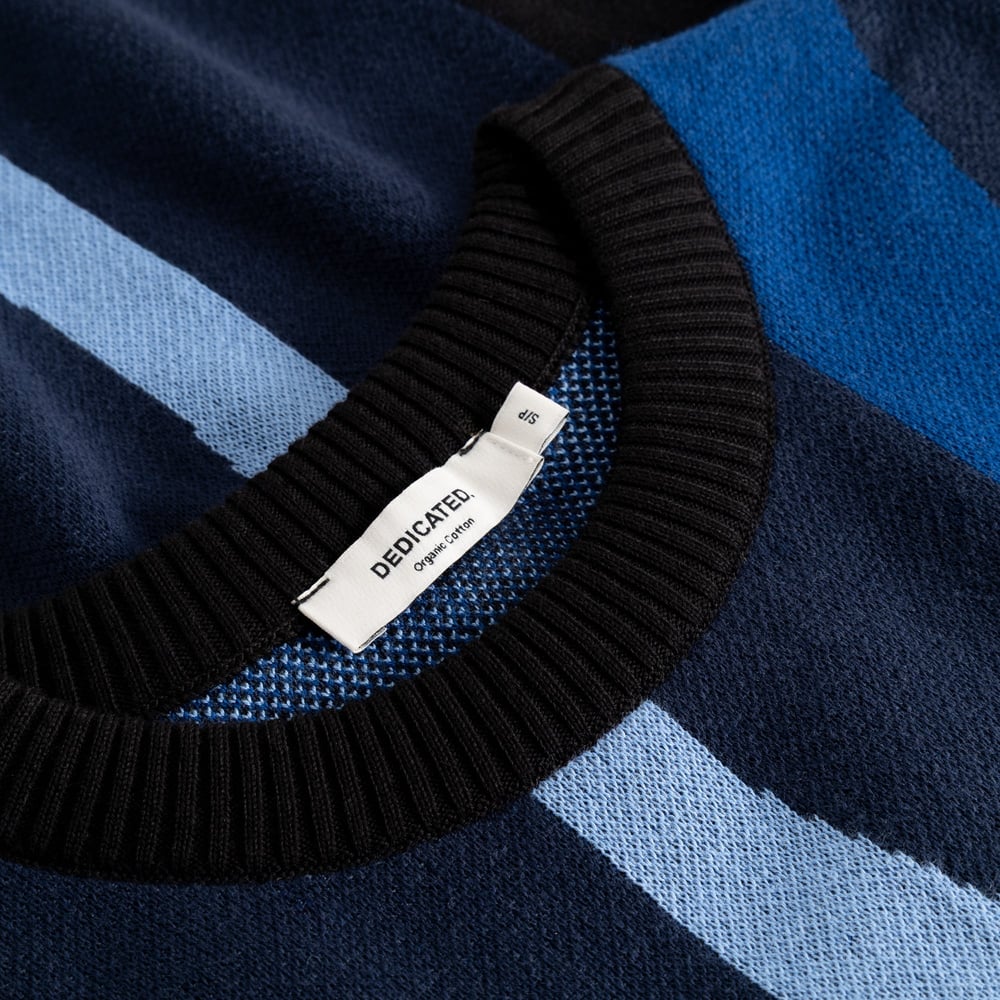 Close-up of the Sweater Arendal Wavy Stripe Blue, showing the organic cotton knit and black ribbed crew neck.