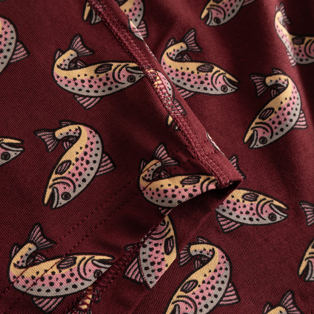 A close-up of the playful trout print on the soft, burgundy fabric of the Kalix Boxer Briefs.