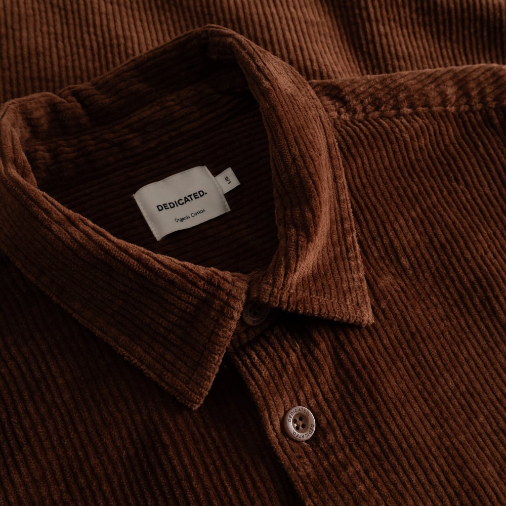 Detailed close-up of the Shirt Kil Corduroy in Cappuccino Brown, showcasing the fabric's texture and collar's brand label.