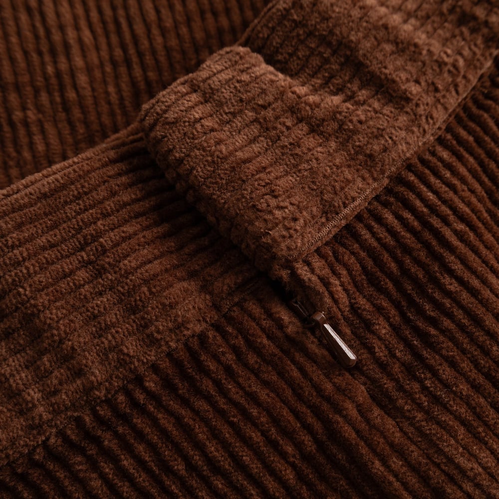 A detailed close-up of the Skirt Majorna's thick cappuccino brown corduroy fabric and its subtle invisible zipper.