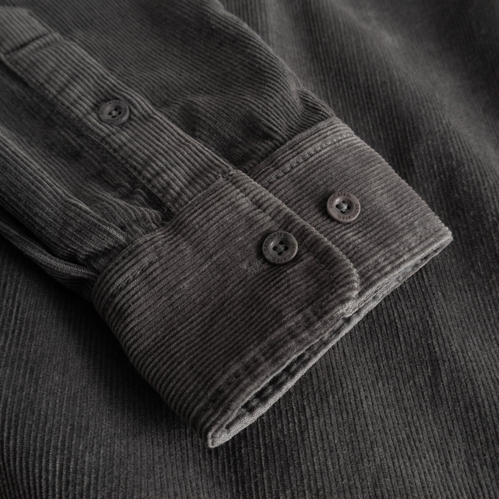 A detailed look at the textured cuff and sleeve of the Varberg Corduroy Shirt in a classic Rock Grey color.