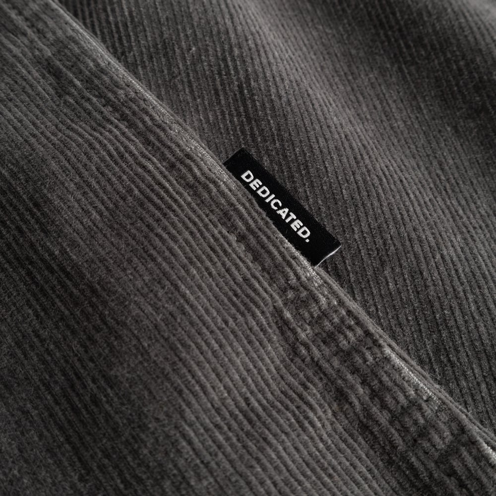 A close-up of the Shirt Varberg Corduroy in Rock Grey, showing the fabric's soft texture and the stitched Dedicated label.