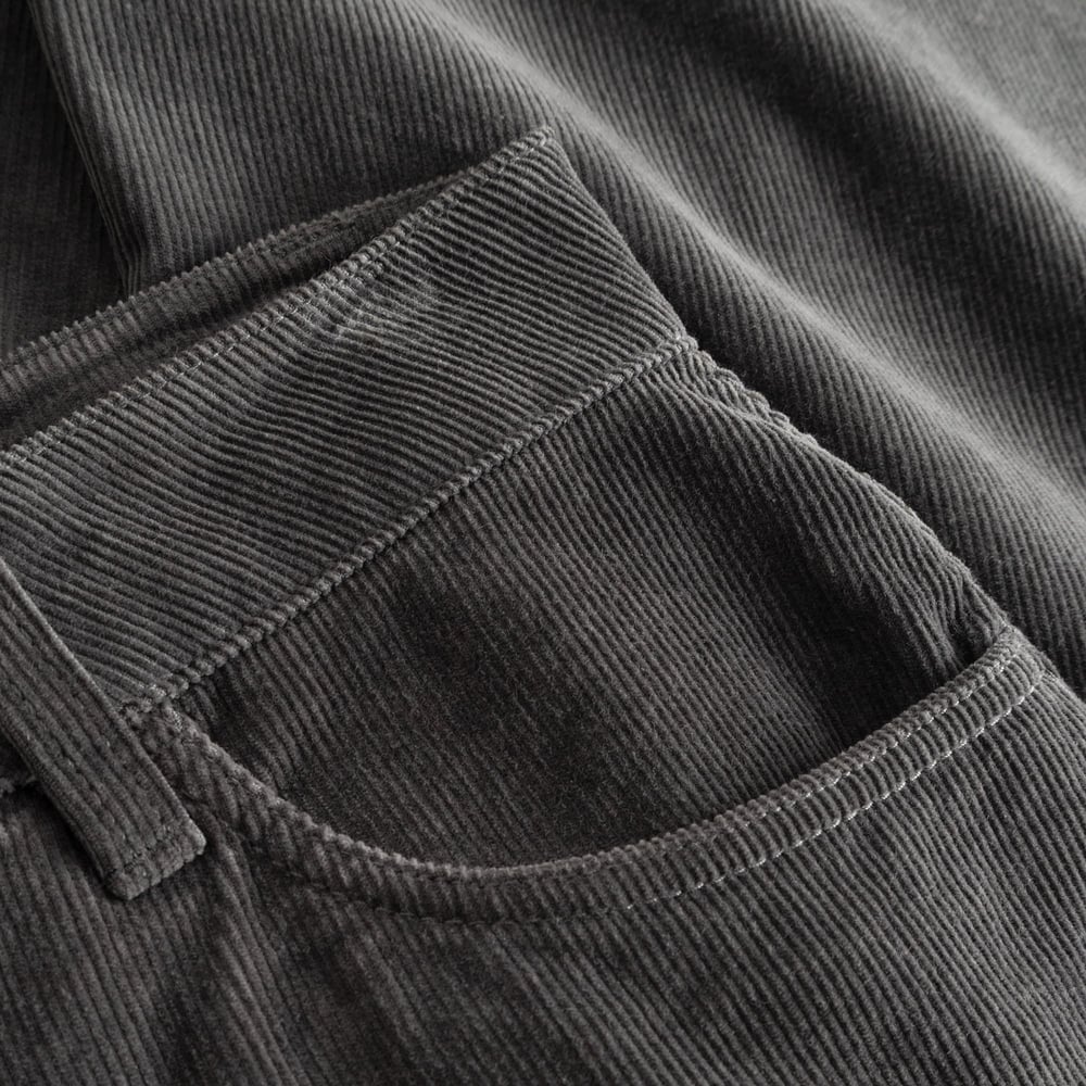 Nahaufnahme der Vordertasche und der feinen Rippenstruktur der Cordhose Ryda in Rock Grey.