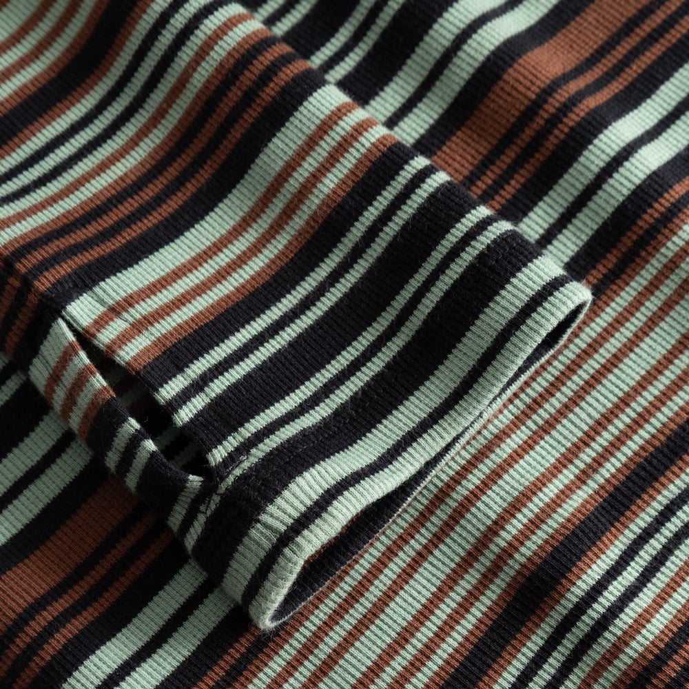 Close-up of the ribbed sleeve on the Lunsen Dress, showing the thumbhole and green, brown, and black irregular stripes.