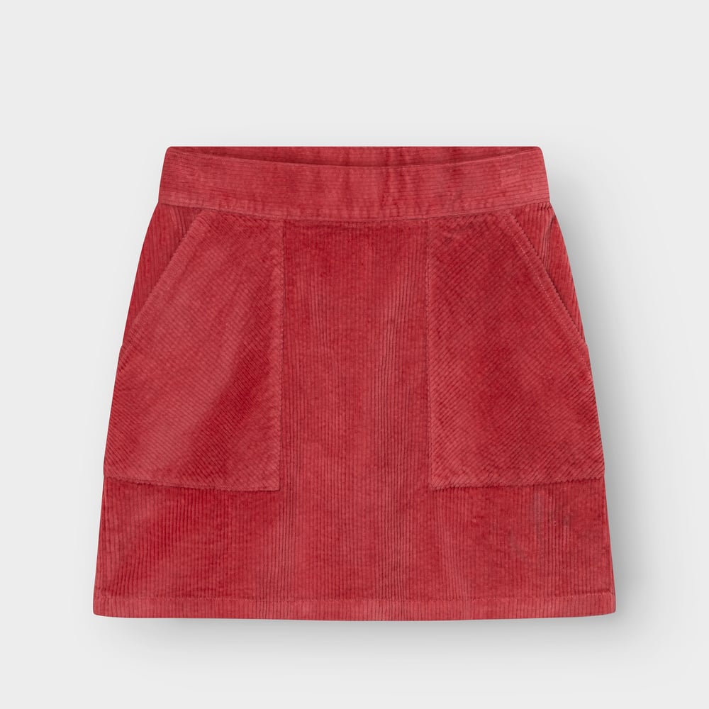 Studio shot of the Skirt Majorna Corduroy in Holly Red, a short A-line skirt with two large front patch pockets.