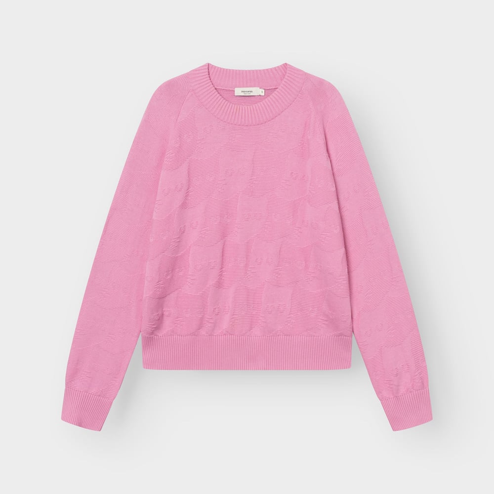 The Husie sweater in a lovely moonlite pink, featuring a playful all-over cat knit pattern, laid flat.