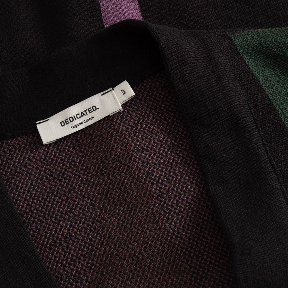 Close-up of the Dedicated brand label and fine knit texture on the collar of the Cardigan Kanan Wavy Stripe Multi Color.