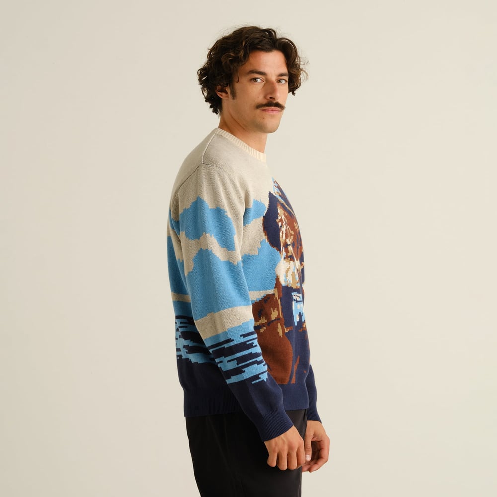 Side view of model wearing Sweater Mora Man and Sea Multi Color, looking back over his shoulder against a plain background.