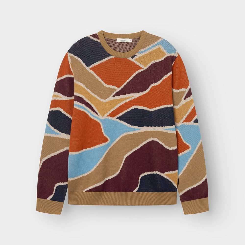 The Sweater Mora Patch Valley laid flat, featuring a colorful jacquard knit pattern inspired by rolling landscapes.