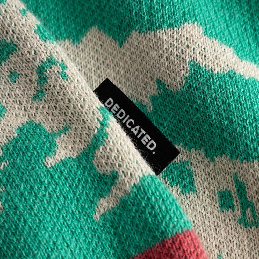 Close-up detail of the Sweater Mora Retro Ski Blocks, showing the colorful jacquard knit and the small Dedicated brand label.