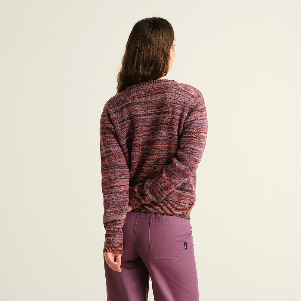 Back view of a model wearing the Arendal TY Swan sweater, a jacquard knit in beautiful multi-colored tones.