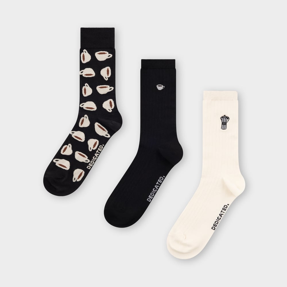 The Socks Coffee 3-pack laid flat, showing off the playful coffee cup print, moka pot, and single cup embroidery.