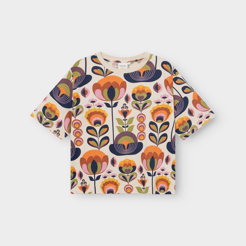 A flat lay of the Vadstena T-shirt, covered in a vibrant and fun retro floral 'Autumn Harvest' print.