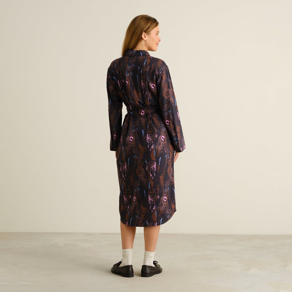 Back view of the Kvilla Shirt Dress in a whimsical owl print, showing off its elegant drape and belted waist.