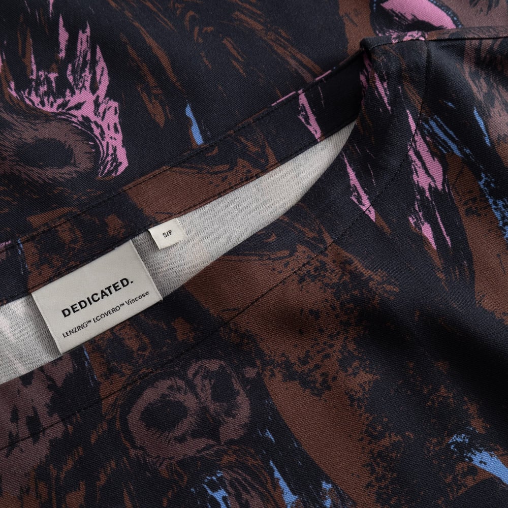 A close-up of the Top Udda Owls shows the boat neckline, brand label, and the detailed, multi-colored owl print fabric.