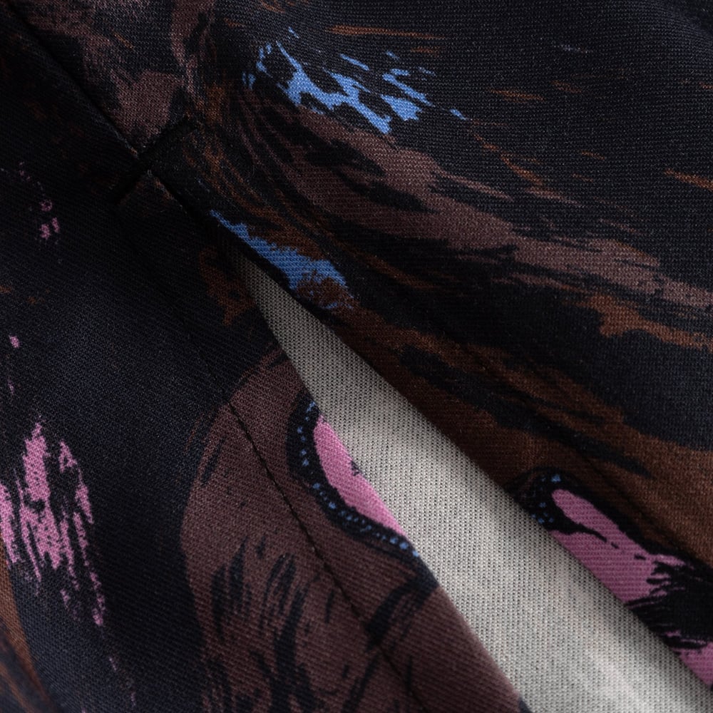 A close-up shot showing the detailed stitching and rich, multi-colored owl pattern on the Viken Skirt.