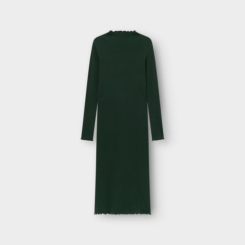Back view of the long-sleeved Rib Dress Lofta in dark green, featuring delicate lettuce edges. Photographed flat.