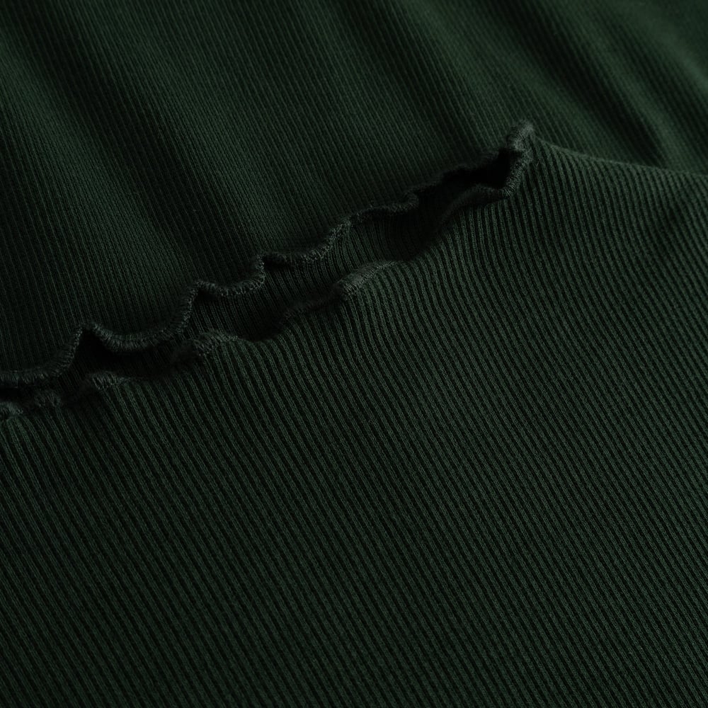 Close-up detail of the Rib Top Ryd in Dark Green, showing the fine ribbing and delicate lettuce-edge seam.