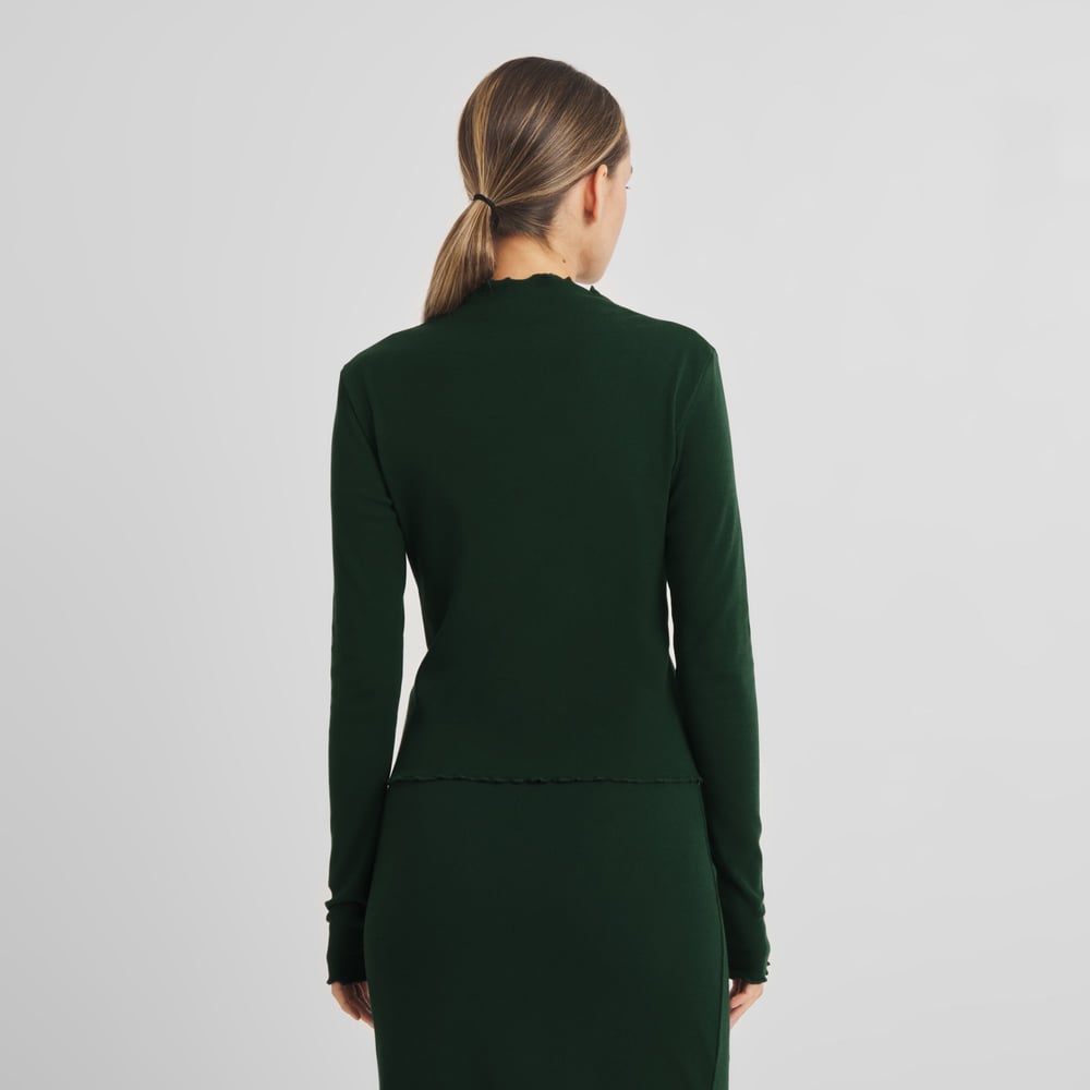 Back view of a woman in our Rib Top Ryd in Dark Green. The perfect slim fit for effortless layering or a sleek matching set.