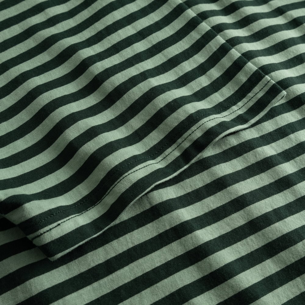 Detailed shot of the organic cotton fabric of the Stockholm T-shirt in a dark green and granite green striped pattern.