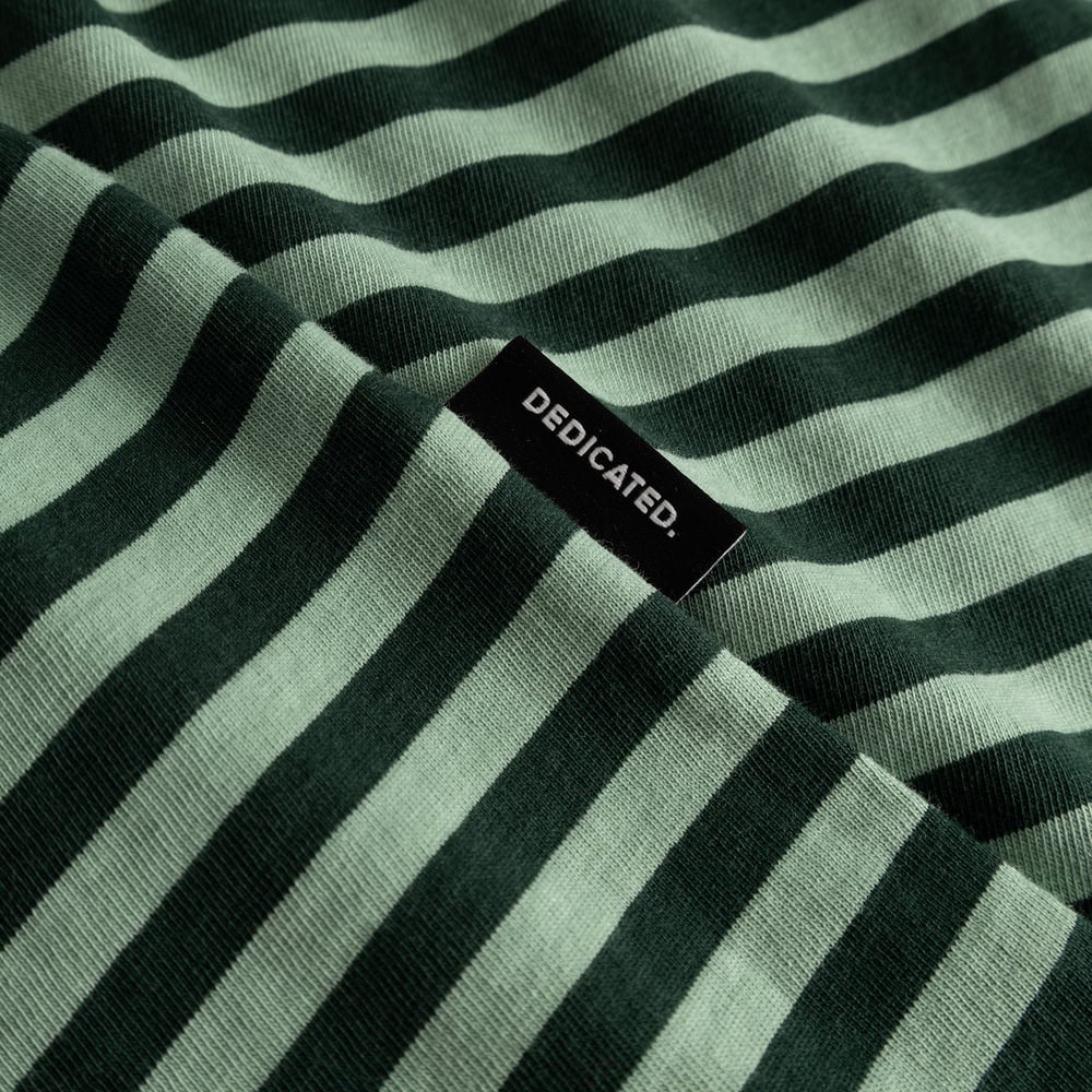Close-up of the T-shirt Stockholm Stripes in dark and granite green, showing the fabric texture and black Dedicated label.