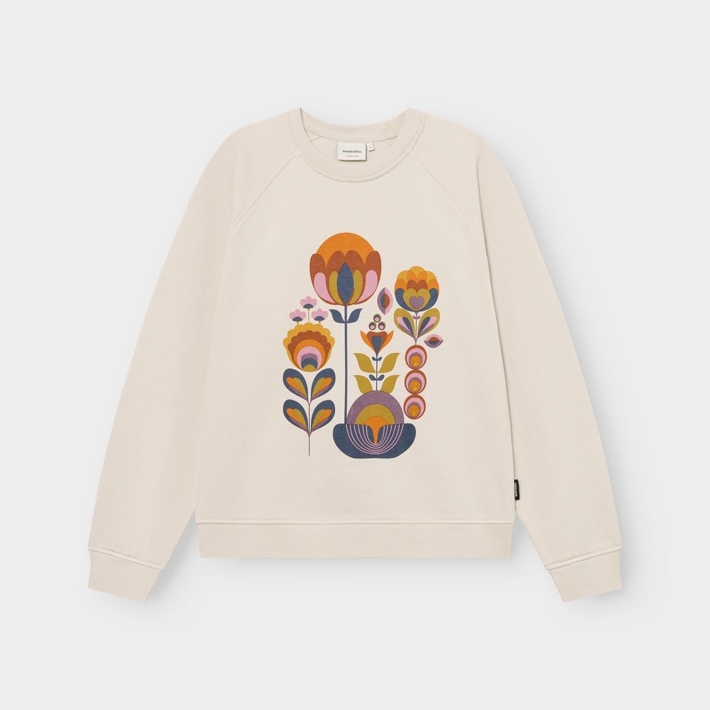 A flat lay of the oat white 'Ystad' sweatshirt, showing off the colorful and stylized 'Autumn Harvest' floral print.