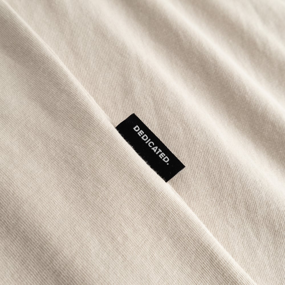 A close-up look at our T-shirt Stockholm in Oat White, featuring the subtle and classic Dedicated side label.