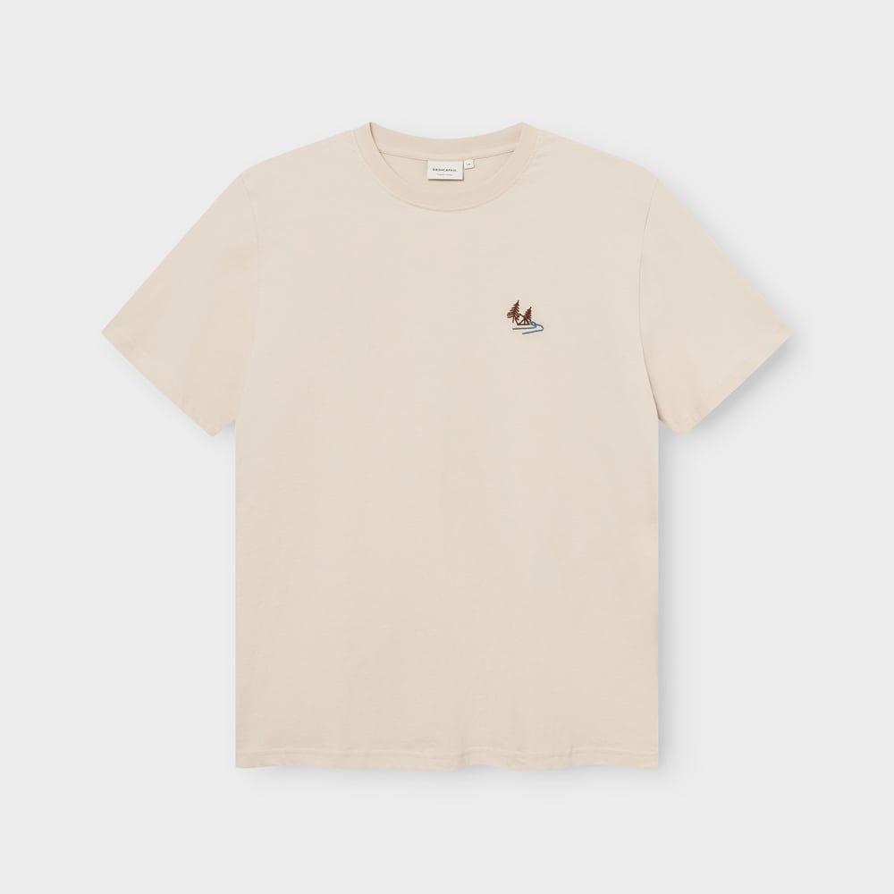 Front view of the T-shirt Stockholm in Oat White, laid flat, with a small embroidered Camp Creek graphic on the chest.