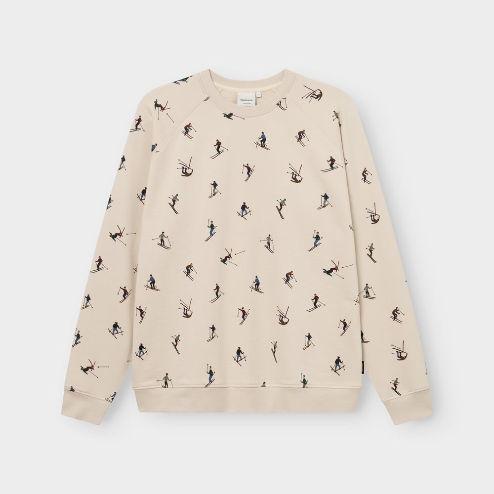 Studio shot of the oat white Sweatshirt Malmoe Ski Team, featuring a fun all-over print of tiny, colorful skiers.