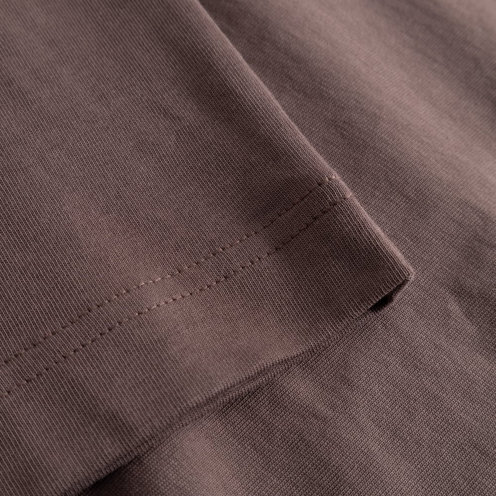 Close-up of the Vreta long-sleeve T-shirt in Sparrow Brown, showing the finely stitched sleeve cuff and soft fabric.