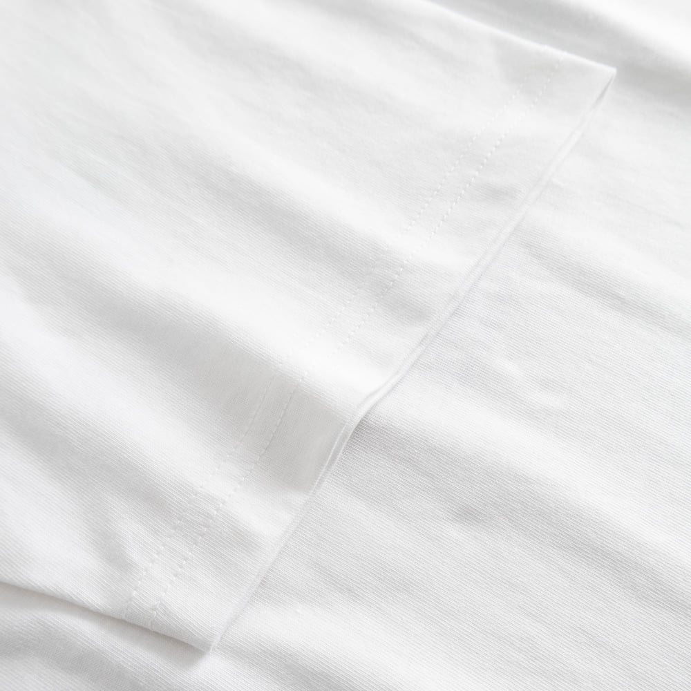 A close-up view showcasing the quality stitching and soft organic cotton fabric of the white Stockholm t-shirt.