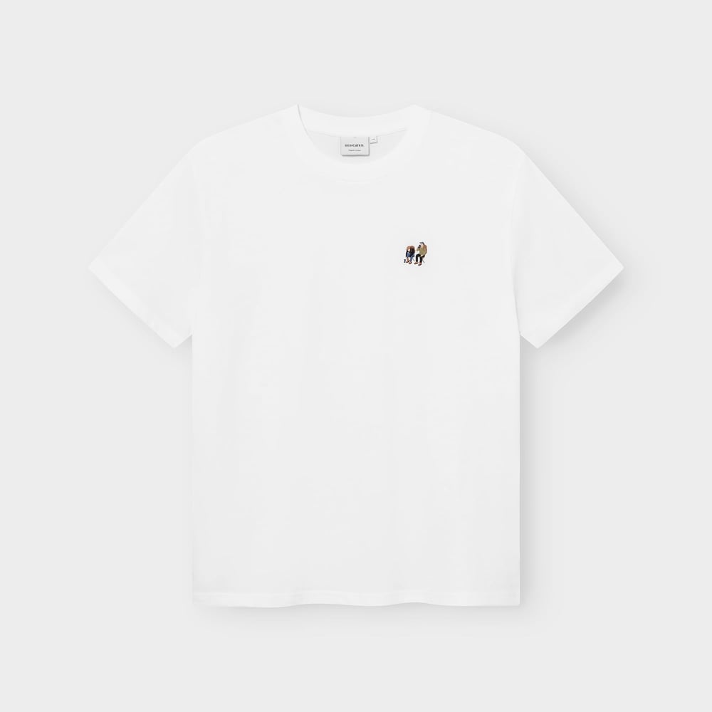 A white t-shirt, the Stockholm Camp Crew, laid flat against a grey background, showing the small embroidery on the chest.