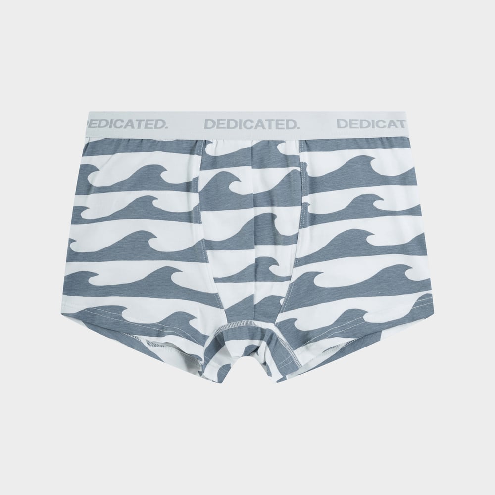 Ein Paar Dedicated Kalix Boxershorts mit Allover-Wellenprint in Grau und Weiß, fotografiert vor einem schlichten Hintergrund.