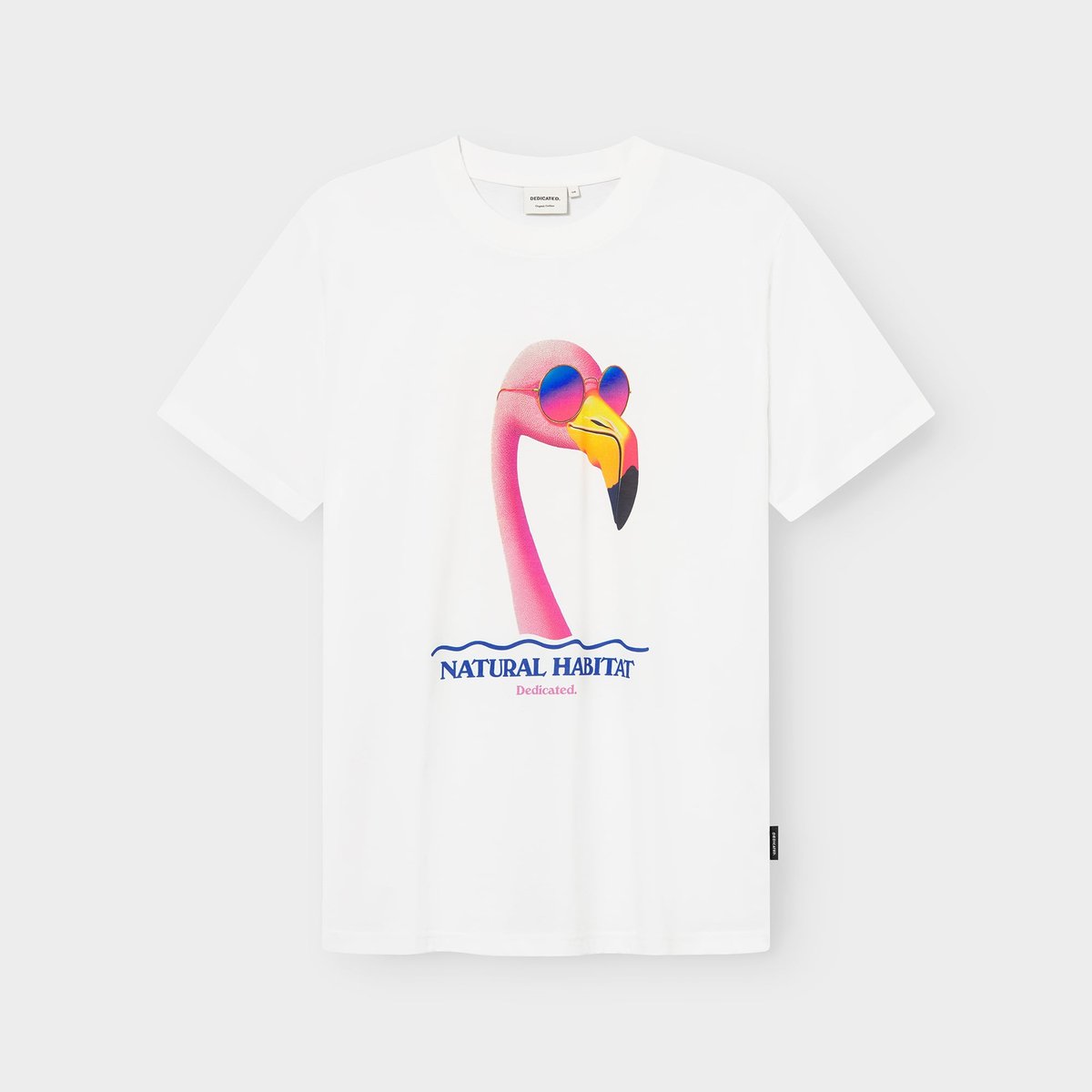 Off-white t-shirt with a graphic of a pink flamingo wearing colourful sunglasses and the text 'Natural Habitat' below.