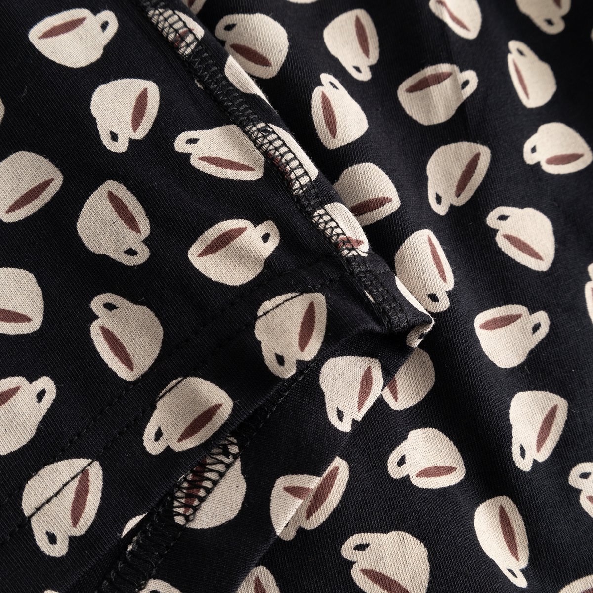 A close-up view of the Kalix Boxer Briefs in black, highlighting the charming all-over coffee cup print and fabric detail.